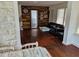 Living room showcasing hardwood floors and a unique wood-paneled wall with decor at 775 36Th S Ave, St Petersburg, FL 33705