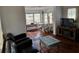 Living room featuring hardwood floors, natural light, and seamless flow to the sun room and dining room at 775 36Th S Ave, St Petersburg, FL 33705