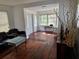 Hardwood floor living room with abundant light, seamlessly connected to the entry and dining room at 775 36Th S Ave, St Petersburg, FL 33705