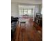 Inviting living room featuring hardwood floors, a comfortable leather sofa, and an open floor plan at 775 36Th S Ave, St Petersburg, FL 33705