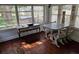 Light-filled sun room featuring wood floors, decorative furniture, and a view of the backyard with a hot tub at 775 36Th S Ave, St Petersburg, FL 33705