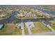 Aerial view showcasing waterfront homes with lush lawns and canal access at 9317 Saint Paul Drive, Port Charlotte, FL 33981
