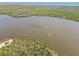Scenic aerial view showcasing boats on the tranquil water surrounded by lush greenery and islands at 9317 Saint Paul Drive, Port Charlotte, FL 33981