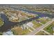 Expansive aerial view of the community, revealing waterfront homes along a winding canal at 9317 Saint Paul Drive, Port Charlotte, FL 33981