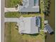High angle view features a home with a well kept yard and a screened pool along the canal at 9317 Saint Paul Drive, Port Charlotte, FL 33981