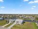 Scenic aerial view of waterfront community with canals, lush lawns, and neighborhood charm at 9317 Saint Paul Drive, Port Charlotte, FL 33981