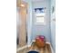 Stylish bathroom with walk-in shower, window, and unique blue accents at 9317 Saint Paul Drive, Port Charlotte, FL 33981