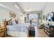 Inviting bedroom with natural light, a cozy bed, and access to the outdoor pool area at 9317 Saint Paul Drive, Port Charlotte, FL 33981