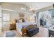 Comfortable bedroom with a ceiling fan, natural light, and access to the outdoor patio at 9317 Saint Paul Drive, Port Charlotte, FL 33981
