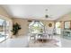 Bright dining area featuring water views, white tile floors, and elegant white table set at 9317 Saint Paul Drive, Port Charlotte, FL 33981