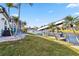 Scenic waterfront home with a dock and lift, set amidst lush landscaping and palm trees at 9317 Saint Paul Drive, Port Charlotte, FL 33981