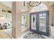 The home's foyer features tile flooring, a chandelier, and an open floor plan to the living area at 9317 Saint Paul Drive, Port Charlotte, FL 33981