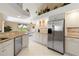 Well-lit kitchen with stainless steel appliances and granite countertops looking into the breakfast nook at 9317 Saint Paul Drive, Port Charlotte, FL 33981