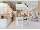 Bright kitchen features white cabinetry, granite countertops, and breakfast bar at 9317 Saint Paul Drive, Port Charlotte, FL 33981