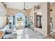 Inviting living room featuring vaulted ceilings, lots of natural light, and stylish coastal decor at 9317 Saint Paul Drive, Port Charlotte, FL 33981