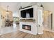 Living room area featuring a fireplace and mounted tv, with open access to a dining area at 9317 Saint Paul Drive, Port Charlotte, FL 33981