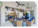 Outdoor patio seating with ceiling fans, a tv and sliding glass doors at 9317 Saint Paul Drive, Port Charlotte, FL 33981
