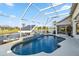 Beautiful screened pool with waterfall feature overlooking a scenic canal view at 9317 Saint Paul Drive, Port Charlotte, FL 33981
