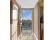 Entrance to a balcony showcasing lovely views of a tranquil waterfront and blue skies at 9393 Midnight Pass Rd # 506, Sarasota, FL 34242