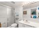 Bathroom featuring glass enclosed shower, mirrored cabinet and vanity at 9393 Midnight Pass Rd # 506, Sarasota, FL 34242