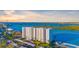 Waterfront condo building featuring private balconies overlooking a bay and lush landscape at 9393 Midnight Pass Rd # 506, Sarasota, FL 34242