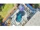 Aerial shot of the screened pool with stone decking, an umbrella, and space for lounge chairs at 965 N Boundry Road, Englewood, FL 34223