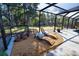 Covered outdoor space featuring gravel and stone flooring, lounge chairs, and privacy from the surrounding trees at 965 N Boundry Road, Englewood, FL 34223