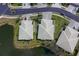 Birds eye view of community houses situated on a pond showcasing neighborhood landscape at 9847 Hawk Nest Ln, North Port, FL 34287