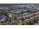 Aerial view of houses nestled around a picturesque lake with lush tropical landscaping at 9847 Hawk Nest Ln, North Port, FL 34287