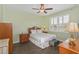 Inviting bedroom featuring natural light, a ceiling fan, and a cozy bed at 9847 Hawk Nest Ln, North Port, FL 34287