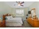 Inviting bedroom featuring natural light, a ceiling fan, and a cozy bed at 9847 Hawk Nest Ln, North Port, FL 34287