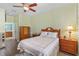 Inviting bedroom featuring natural light, a ceiling fan, and a cozy bed at 9847 Hawk Nest Ln, North Port, FL 34287