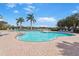 Resort-style community pool with comfortable seating and lush landscaping, perfect for relaxation at 9847 Hawk Nest Ln, North Port, FL 34287