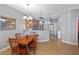 Bright and airy dining area with tile flooring seamlessly connecting to the kitchen and living spaces at 9847 Hawk Nest Ln, North Port, FL 34287
