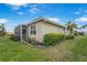 Exterior view of home featuring a screened lanai and meticulously maintained landscaping at 9847 Hawk Nest Ln, North Port, FL 34287