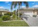Beautiful home with lush landscaping and a well-manicured lawn at 9847 Hawk Nest Ln, North Port, FL 34287