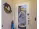 Charming front door with decorative glass and a seasonal wreath at 9847 Hawk Nest Ln, North Port, FL 34287