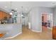 Hallway with tile floors that connects to the living spaces, kitchen and the doorway to an office space at 9847 Hawk Nest Ln, North Port, FL 34287