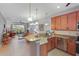 Open-concept kitchen with granite counters seamlessly flows into the living area, perfect for entertaining at 9847 Hawk Nest Ln, North Port, FL 34287