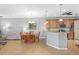 Open-concept kitchen and dining area with tile floors, pendant lighting, and modern appliances at 9847 Hawk Nest Ln, North Port, FL 34287