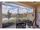Relaxing screened-in lanai with peaceful lake view and rocking chairs for enjoying the outdoors at 9847 Hawk Nest Ln, North Port, FL 34287