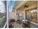 Screened-in lanai with lake views, perfect for outdoor relaxation and potted plants at 9847 Hawk Nest Ln, North Port, FL 34287