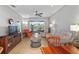 Comfortable living room with large windows and access to the outdoor lanai space and pond views at 9847 Hawk Nest Ln, North Port, FL 34287