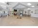 Bright meeting room with tables, TV, ceiling fans, and expansive tile flooring at 9847 Hawk Nest Ln, North Port, FL 34287