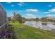 Wide angle shot of a pond behind a home, with additional homes across the water at 9847 Hawk Nest Ln, North Port, FL 34287