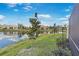 Exterior view of a pond behind a home, with additional houses visible across the water at 9847 Hawk Nest Ln, North Port, FL 34287