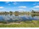 This home features a lovely backyard pond view and well manicured lawn at 9847 Hawk Nest Ln, North Port, FL 34287