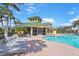 Community pool featuring a bathhouse, lounge chairs, and well-maintained brick patio at 9847 Hawk Nest Ln, North Port, FL 34287