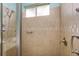 This bathroom shower is tiled with a neutral tile and has modern hardware at 9847 Hawk Nest Ln, North Port, FL 34287