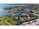 Aerial view showcasing a resort-style pool, bocce ball court, playground, and picturesque waterfront at 995 Waterline Ct, Sarasota, FL 34240